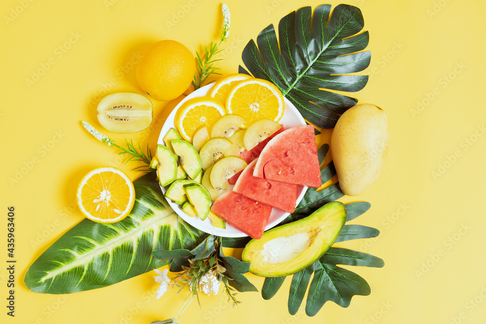 Chopped tropical fruit in bowls and plates