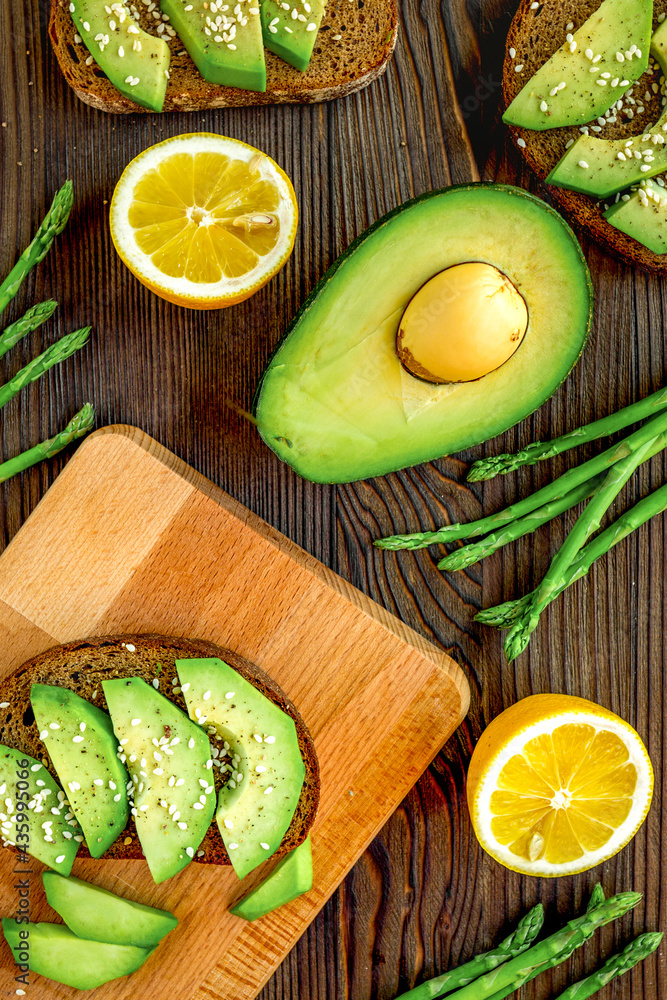 sliced avocado for homemade sandwiches on kitchen table top view