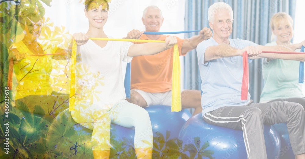 Composition of female instructor senior man and women exercising with rubber bands with tree overlay