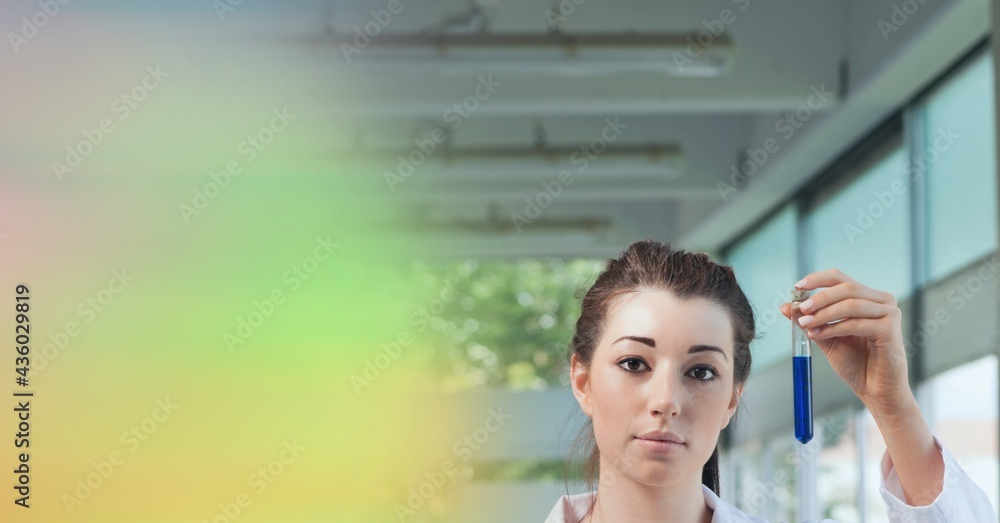 Composition of female lab technician holding test tube of blue liquid, with yellow blur copy space