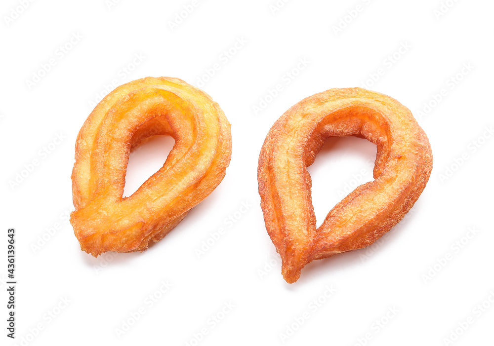 Tasty churros on white background