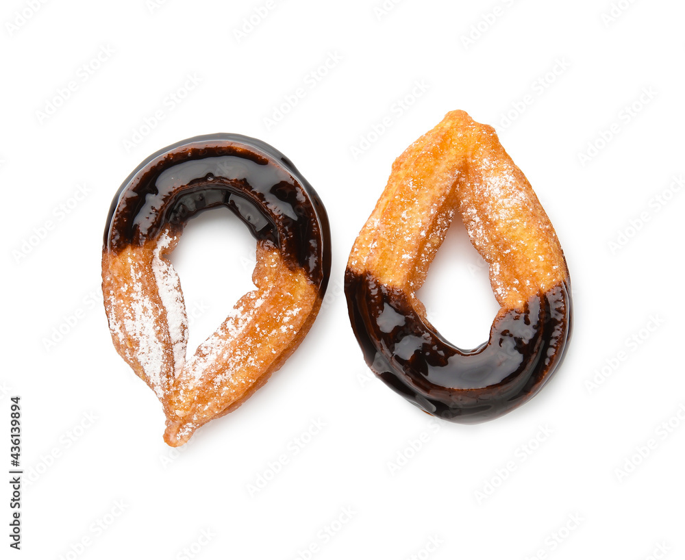 Tasty churros dipped in chocolate on white background