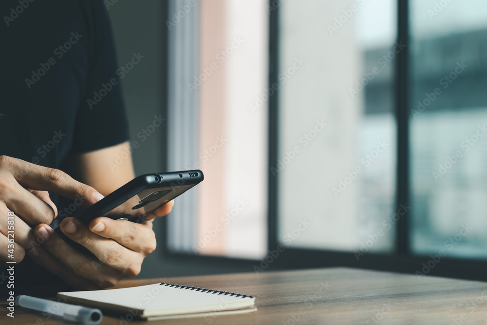 young man using a smartphone at the office.