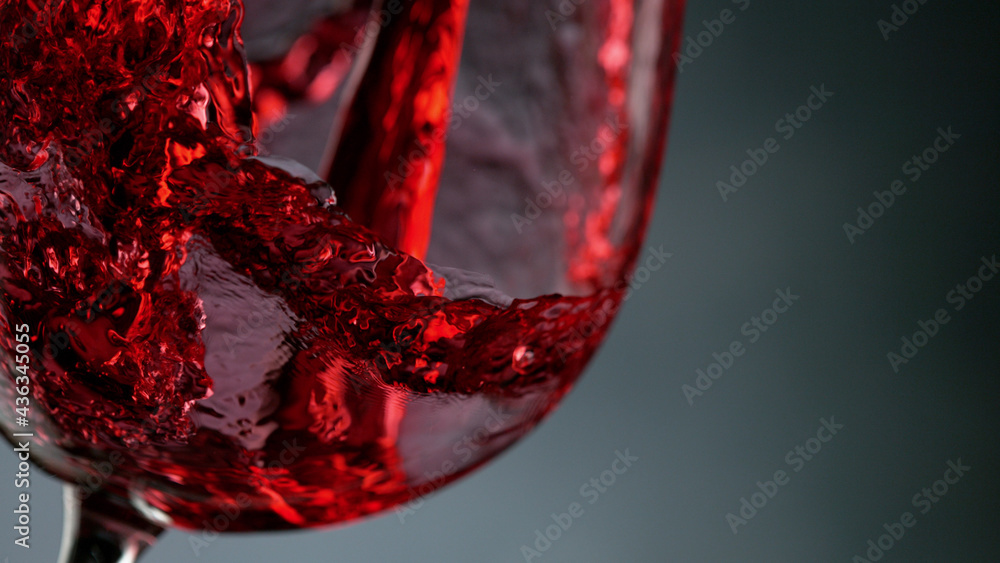 Glass of red wine on dark background closeup