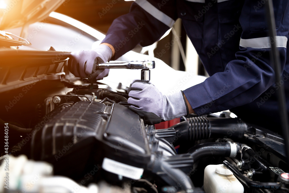 Auto mechanic working on car engine in mechanics garage.Repair service,car service, repair, maintena