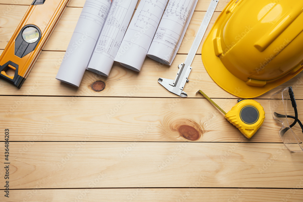 Work safety. Standard Construction site protective equipment on  top view wooden background, flat la