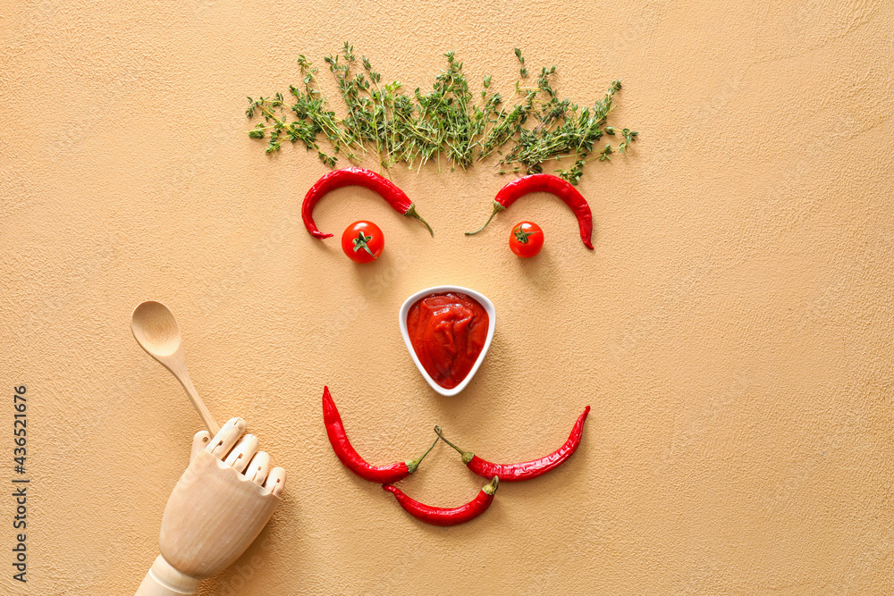 Creative composition with tasty chili sauce, ingredients and wooden hand on color background