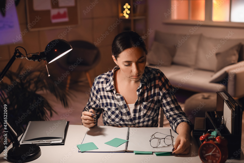 Beautiful woman working in office at night