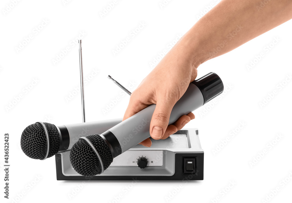 Female hand with modern microphones and audio system on white background