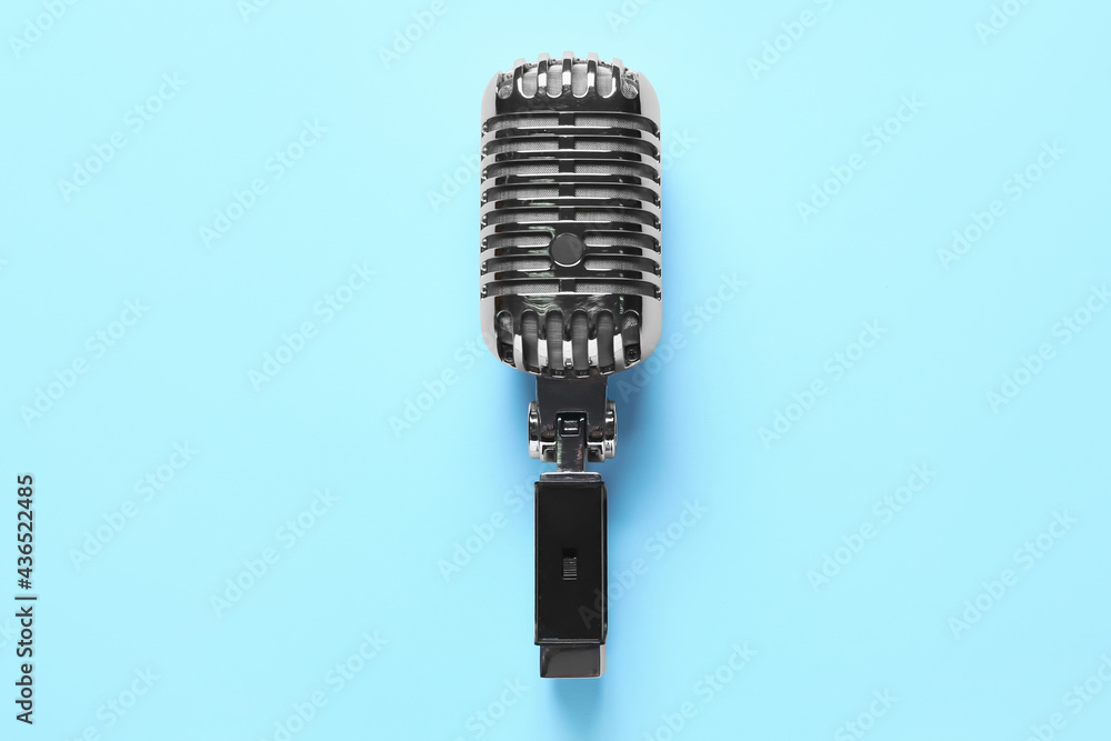 Retro microphone on color background