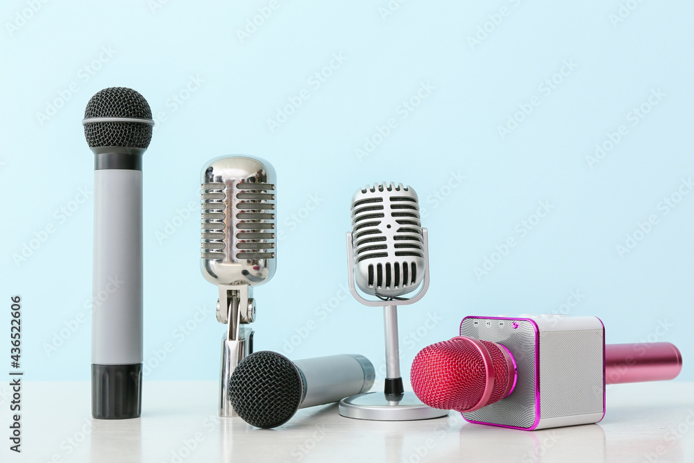 Different microphones on color background