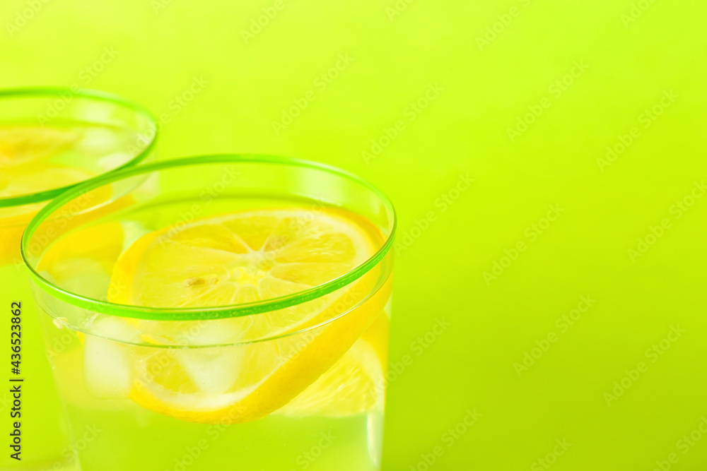 Glasses of tasty cold lemonade on color background, closeup