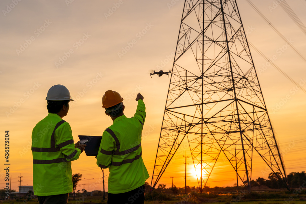 Team work of Engineers location help Technician use drone to fly inspections at the electric power s