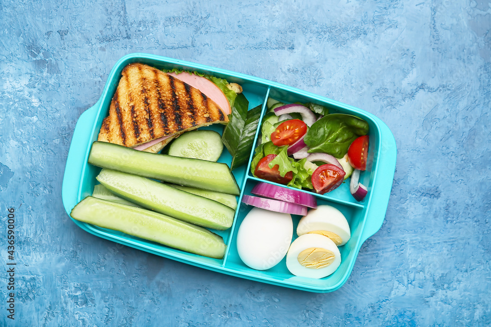 Lunchbox with tasty food on color background