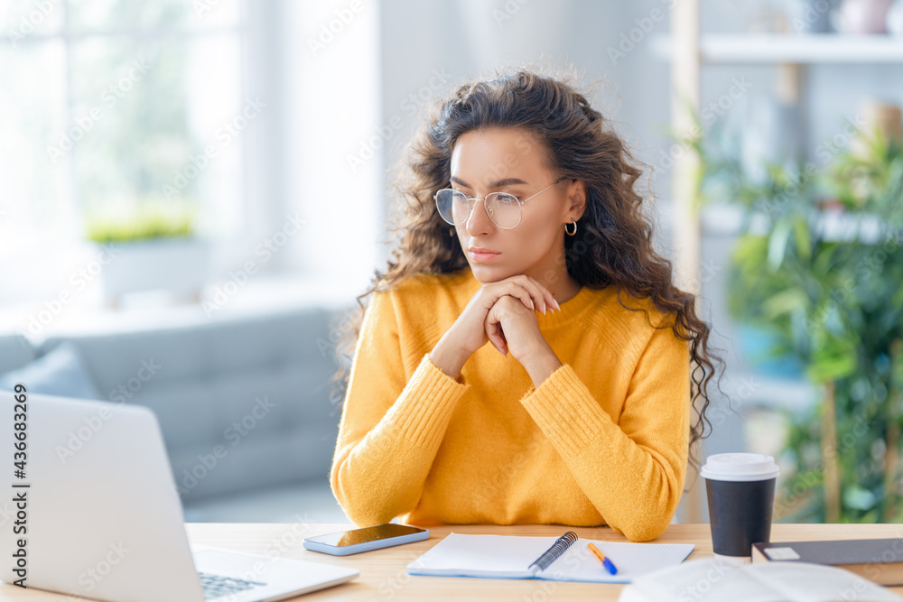 woman working on laptop at home.