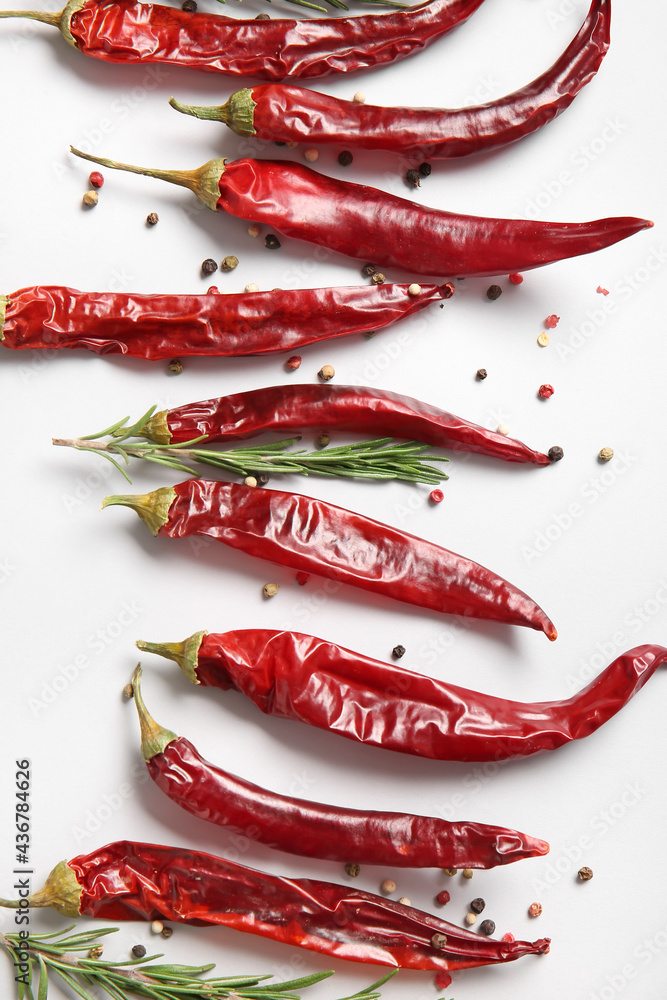 Dry hot chili peppers and spices on white background