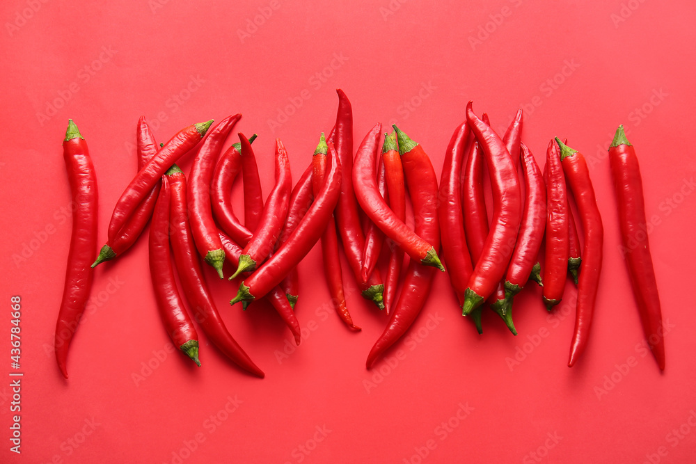 Hot chili peppers on color background