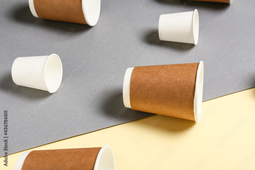 Blank paper cups on color background, closeup