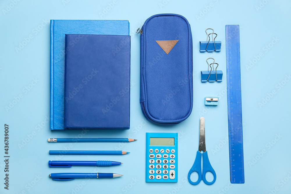 Pencil case and stationery on color background