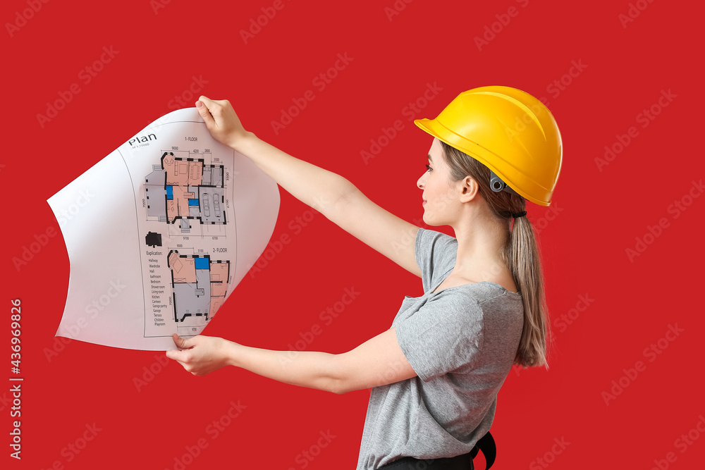 Beautiful female electrician with house plan on color background