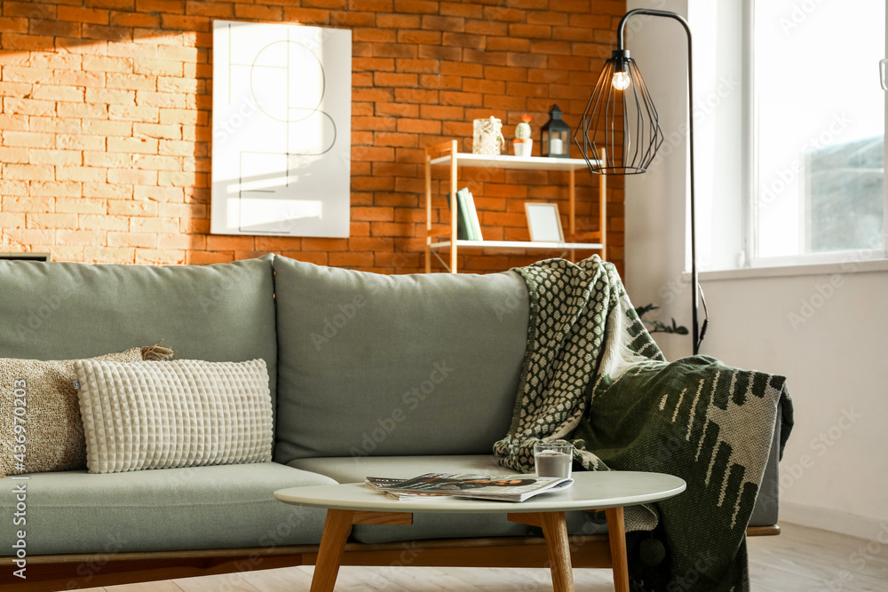 Interior of stylish living room with glowing lamp