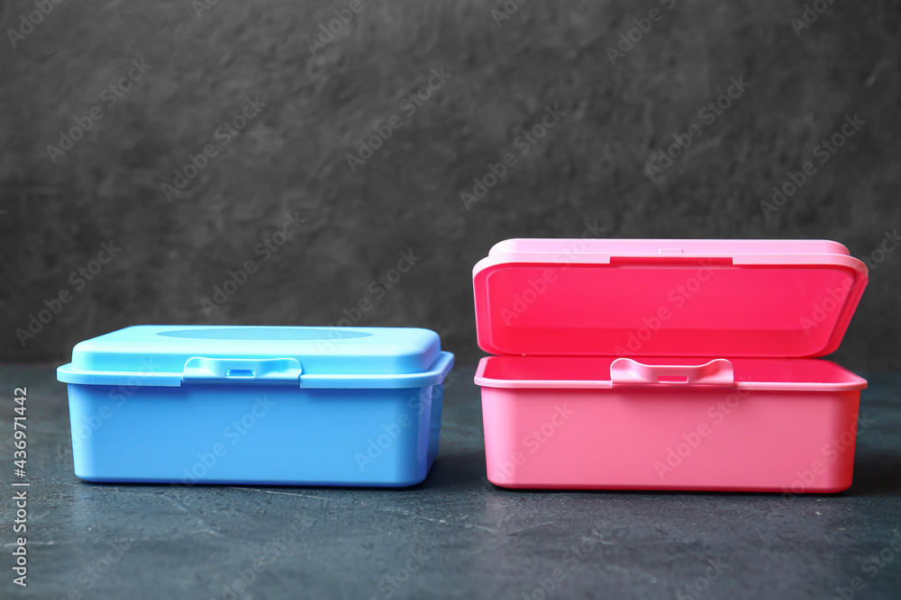 Plastic lunch boxes on dark background