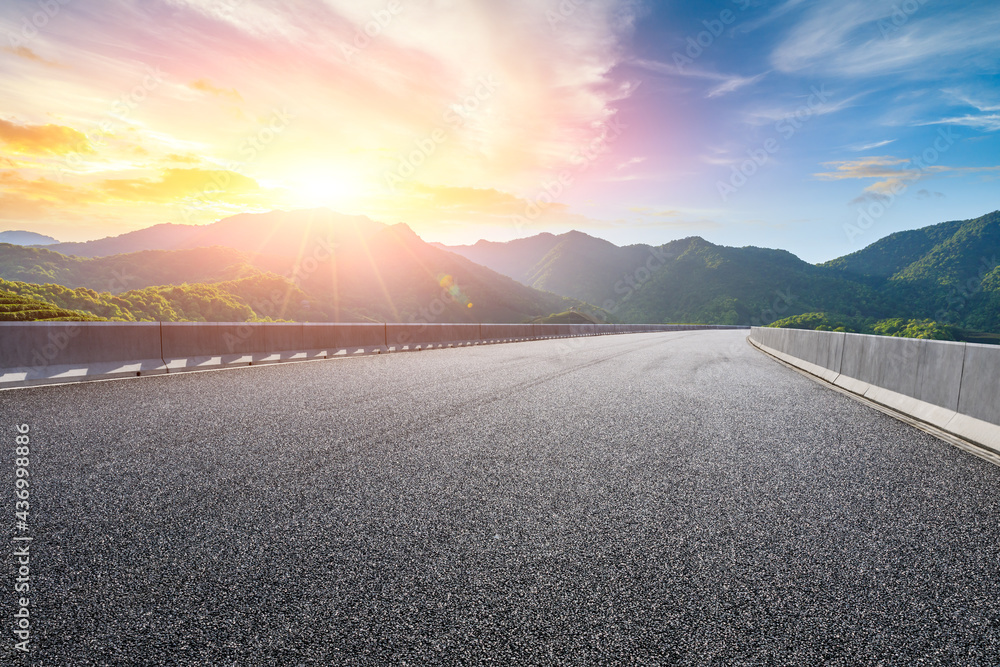 日落时的沥青公路和山脉景观，路面背景。