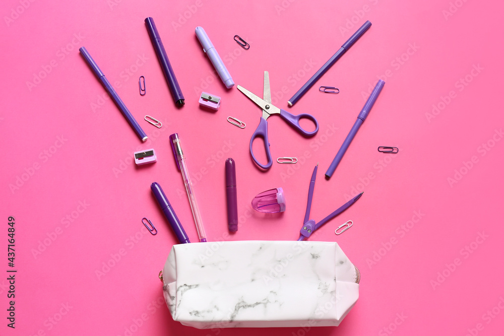 Pencil case with stationery on color background