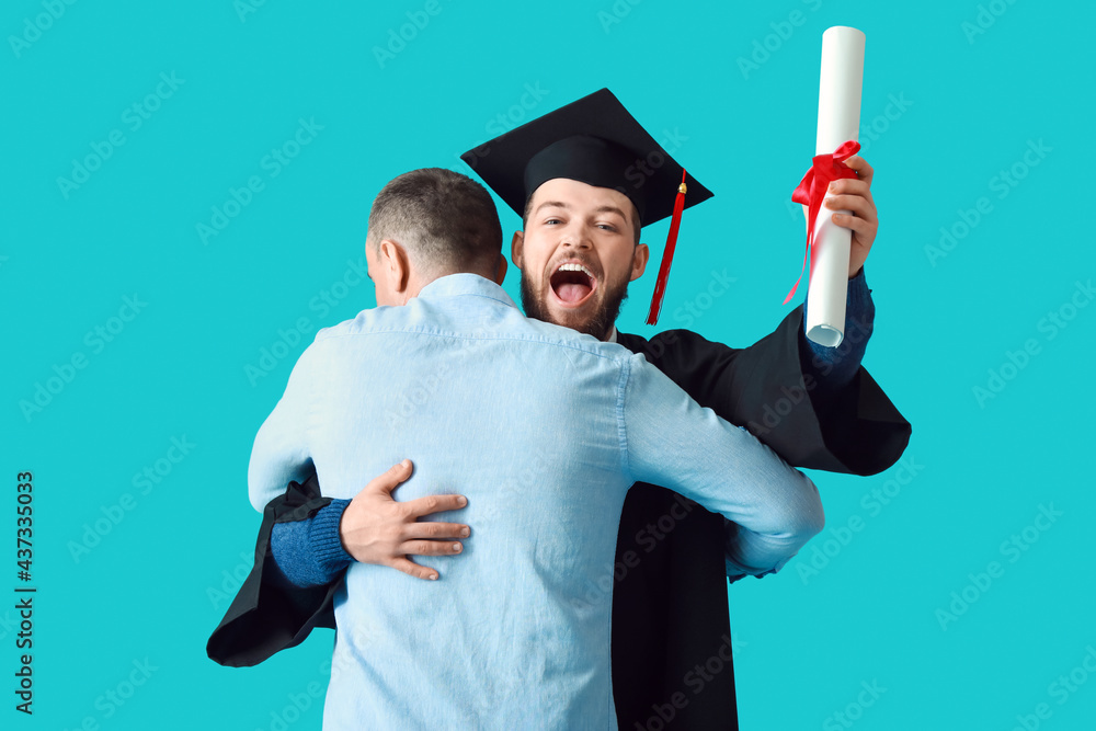 Happy male graduation student with his father on color background