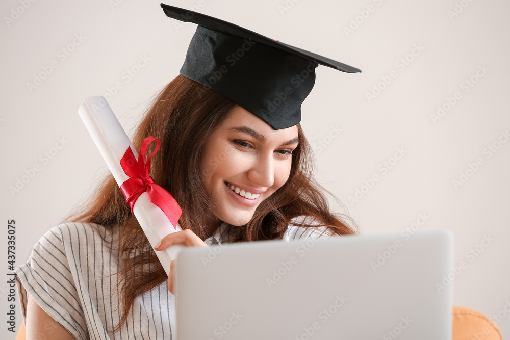 Happy female student on her graduation day at home. Concept of studying online