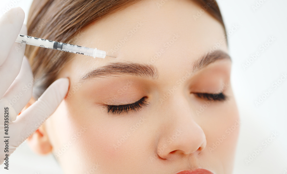 Woman getting beauty injection on face