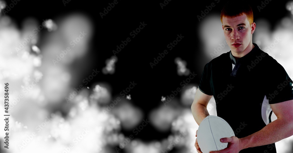 Compostion of caucasian rugby player holding ball on black background with white blur