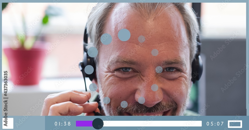 Composition of businessman talking on headset on video playback interface screen