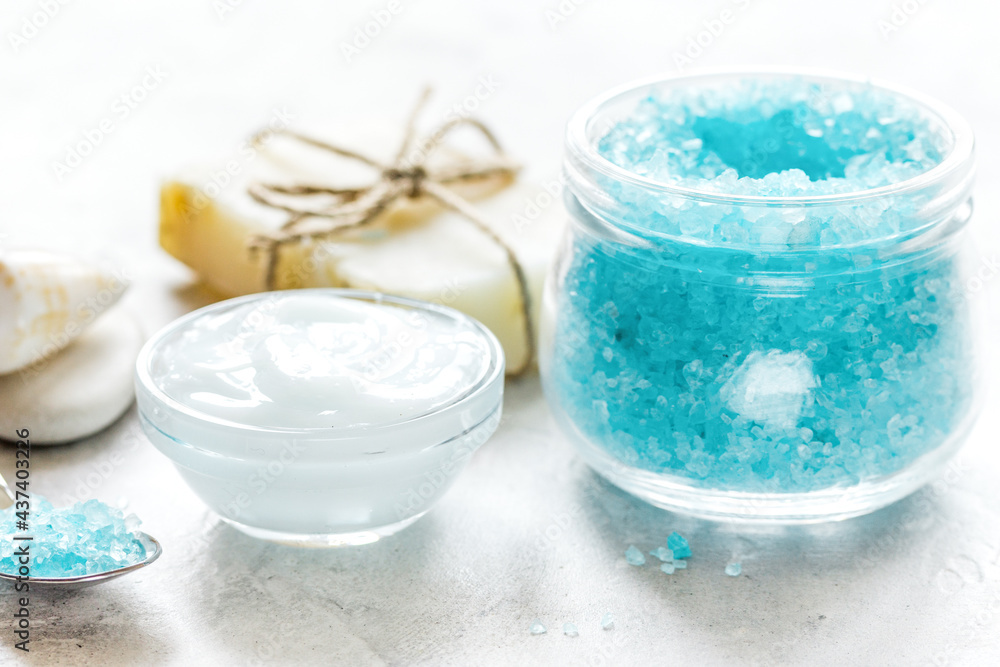 blue sea salt, soap and body cream on stone desk background