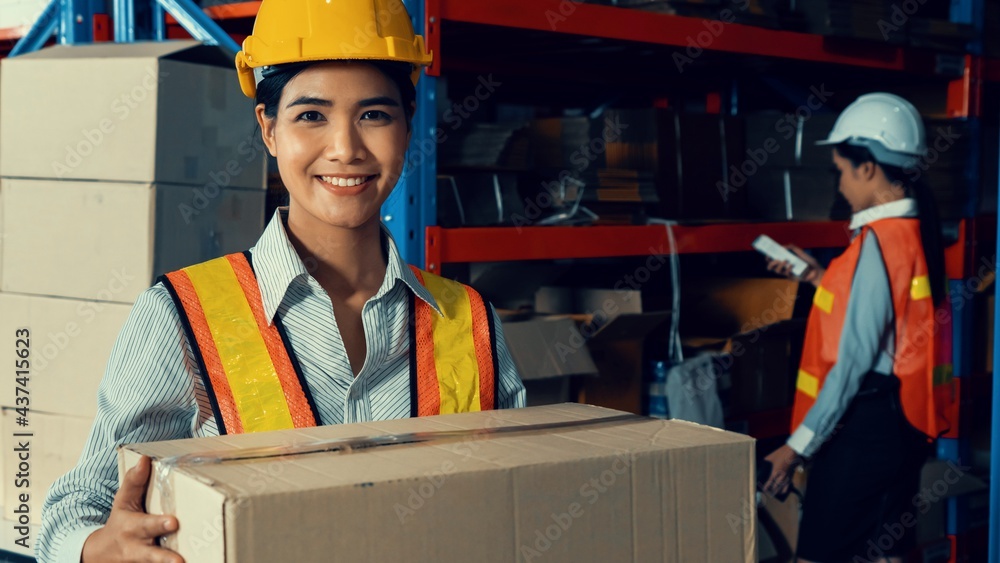 Portrait of young Asian woman warehouse worker smiling in the storehouse . Logistics , supply chain 