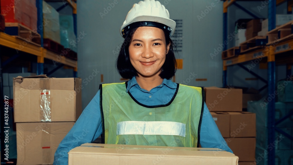 Portrait of young Asian woman warehouse worker smiling in the storehouse . Logistics , supply chain 