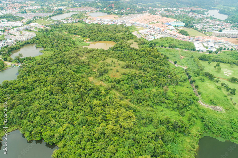 Aerial view drone Top down shot of abundant forest with the city surrounds forest in summer time Hig