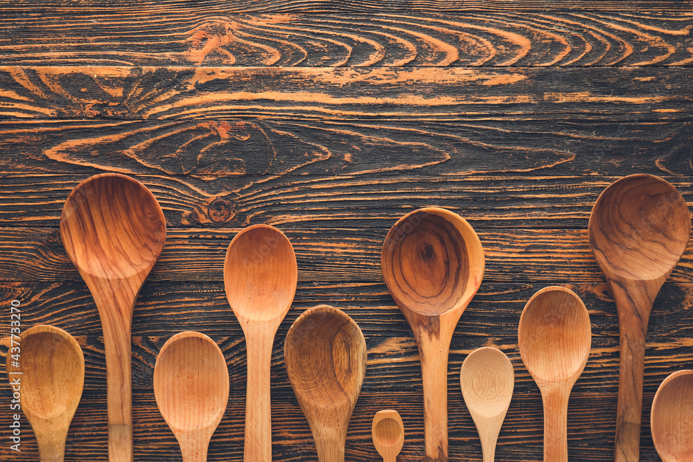 Clean spoons on wooden background