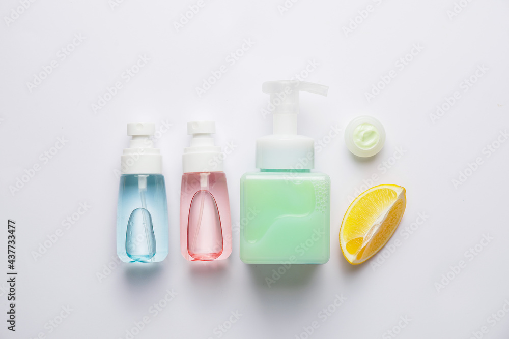 Natural cosmetic products with citrus fruit on white background