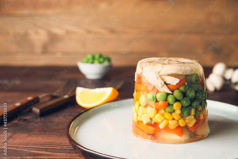 Plate with tasty aspic on table