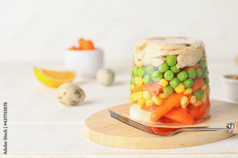 Board with tasty aspic on table