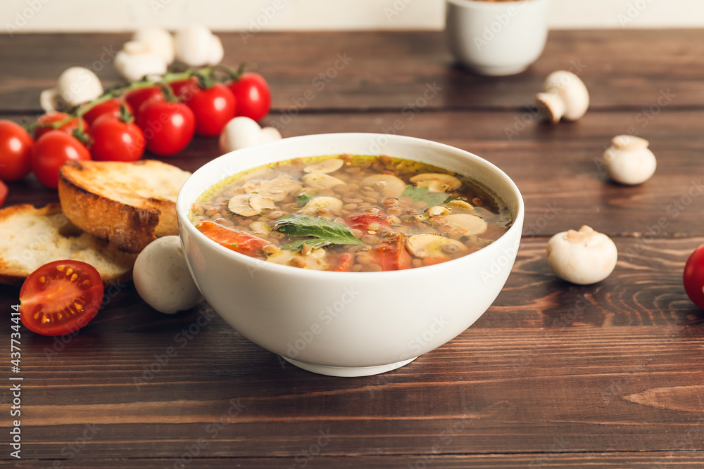 Bowl of tasty lentil soup on table