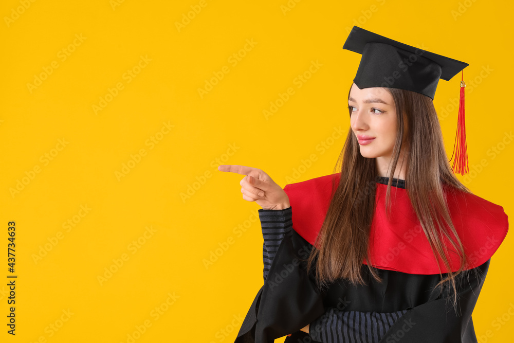 Female graduating student showing something on color background