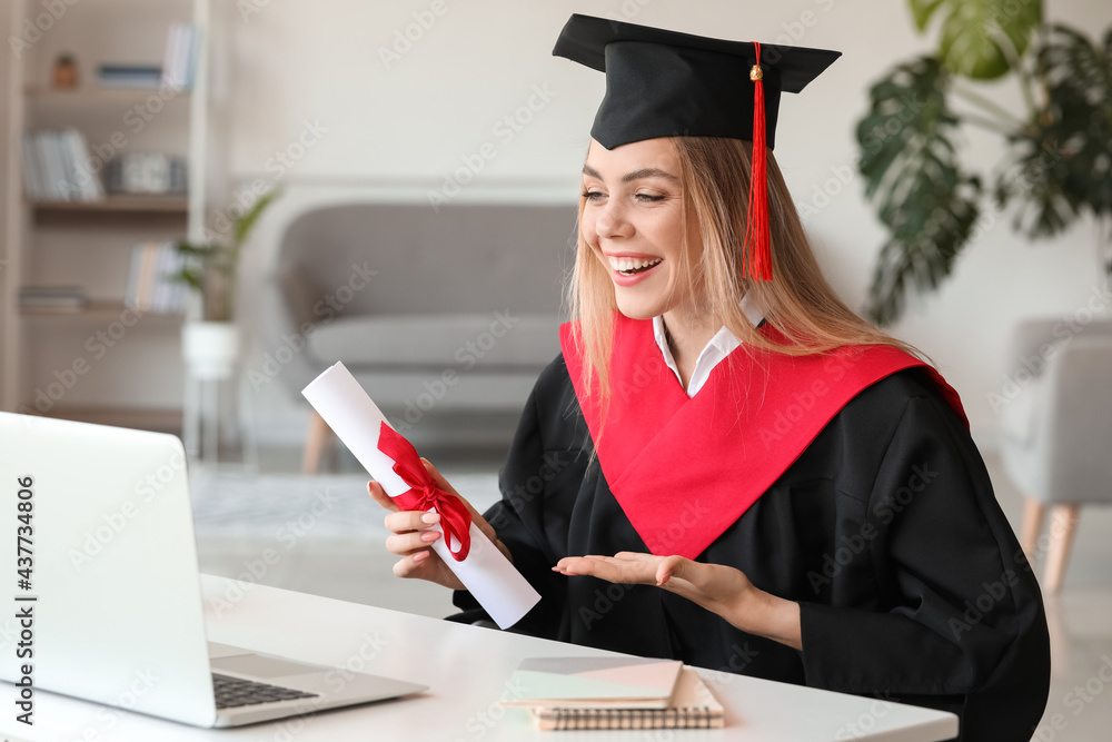 Happy female student on her graduation day at home. Concept of online education