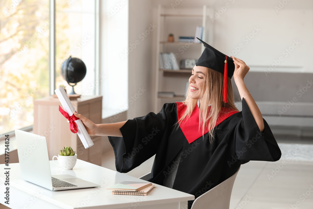 Happy female student on her graduation day at home. Concept of online education