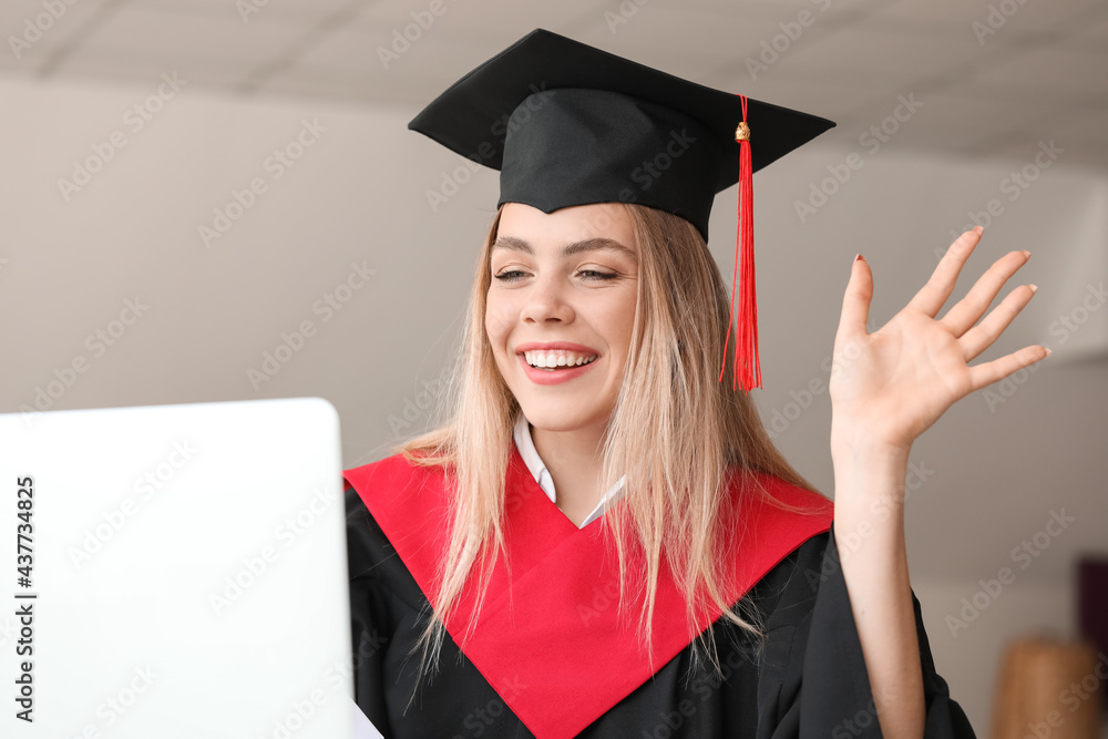 Happy female student on her graduation day at home. Concept of online education