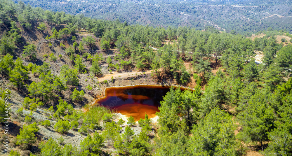 Forest restoration in abandoned opencast mining pit near Kinousa, Cyprus. Aerial view of copper mine