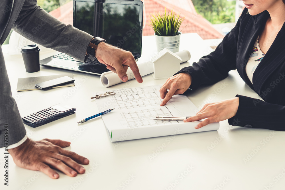 Architect and engineer working with construction drawing project on table in office. Architecture an