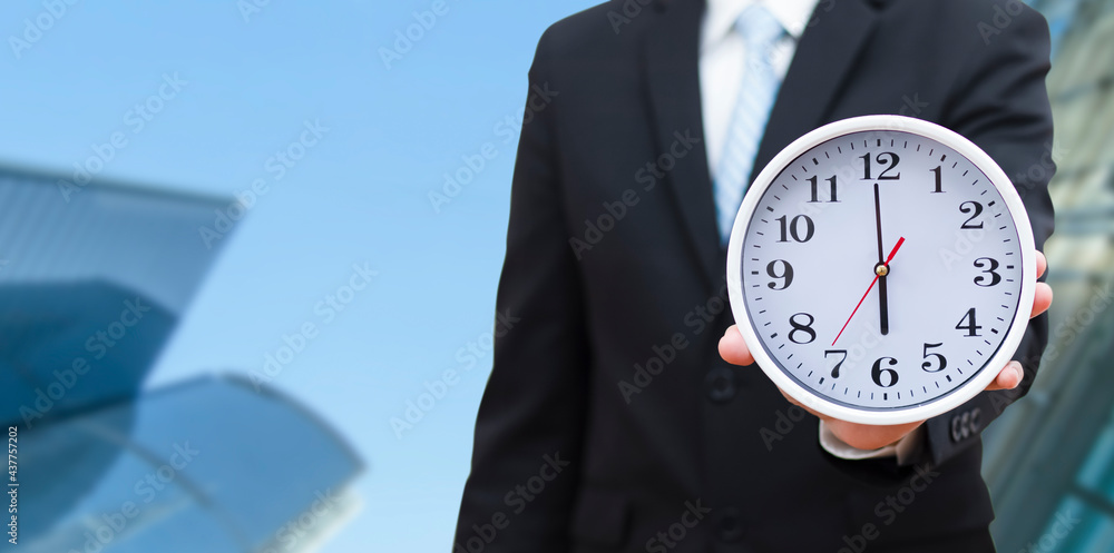 Concept of saving time, Businessman holding a clock against time 6 am in the morning on the White ba