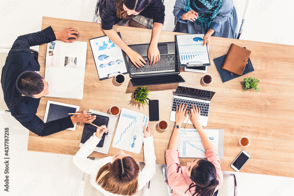 Top view of businessman executive in group meeting with other businessmen and businesswomen in moder